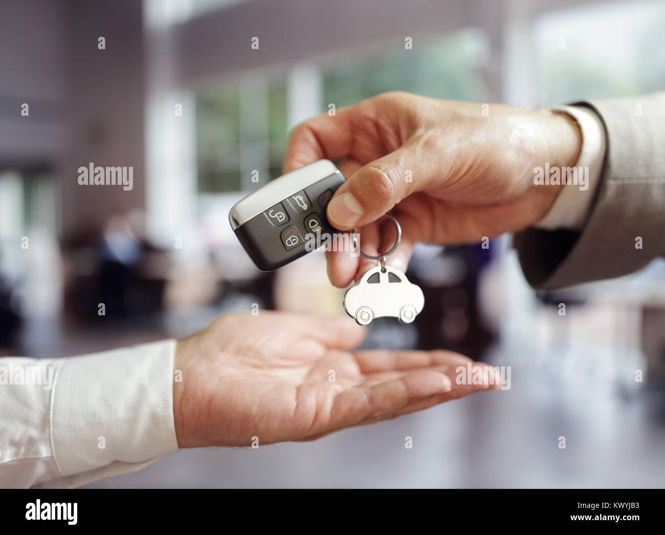 car-sales-buying-a-new-car-handing-over-the-keys-KWYJB3